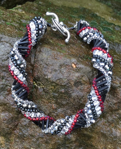 This meticulously woven Helix Spiral Bracelet includes Czech fire-polished glass beads in Crystal, Red, Black and Metallic gray.   8 1/4" and 8 1/2"