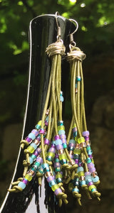 Breezy and dangling olive green leather cords with lime, turquoise, purple and light blue seed beads, these Cattail Style Leather Earrings measure approximately 3 1/2