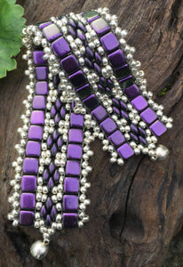 This bead woven bracelet combines velvety Dark Purple Czech Glass tiles with Silver glass seed beads and measures 6 5/8".