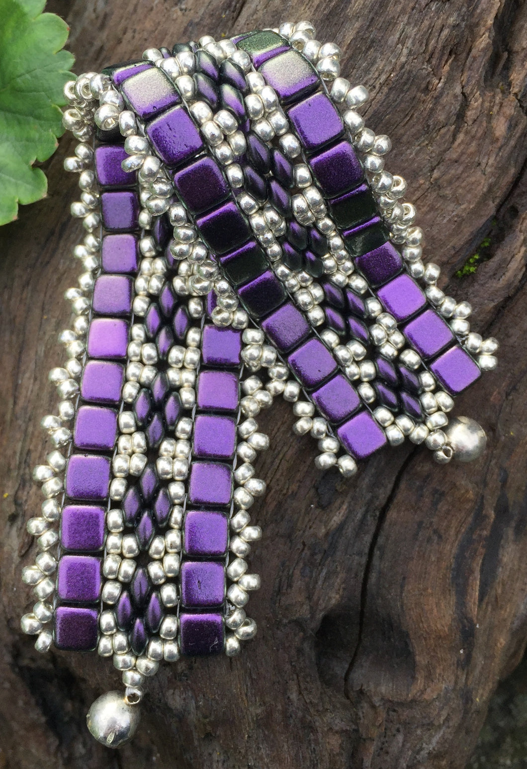 This bead woven bracelet combines velvety Dark Purple Czech Glass tiles with Silver glass seed beads and measures 6 5/8
