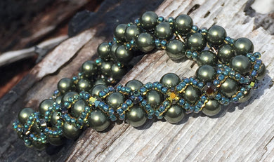 Dark and sparkly, this Dark Olive glass pearl bracelet is entwined with Capri Blue seed beads and rich warm Swarovski Golden Tabac Crystal Montees. This bracelet has a magnetic closure and measures 7 3/8