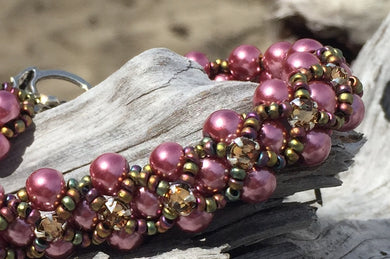 This Rose colored glass pearl bracelet is topped with Topaz Swarovski Montees and Matte Iris seed beads and measures 6 3/4