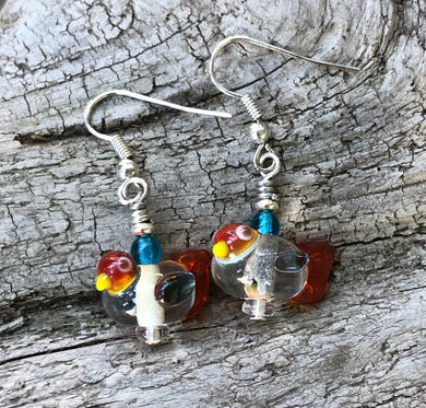 These sweet and tiny clear and orange lampwork glass birds dangles measure 3/4