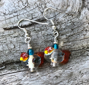 These sweet and tiny clear and orange lampwork glass birds dangles measure 3/4".