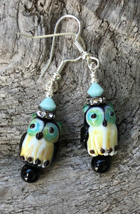 These Black and Aqua Owl Lampwork Glass Earrings are topped with Aqua Swarovski Crystals and measure just under 2".