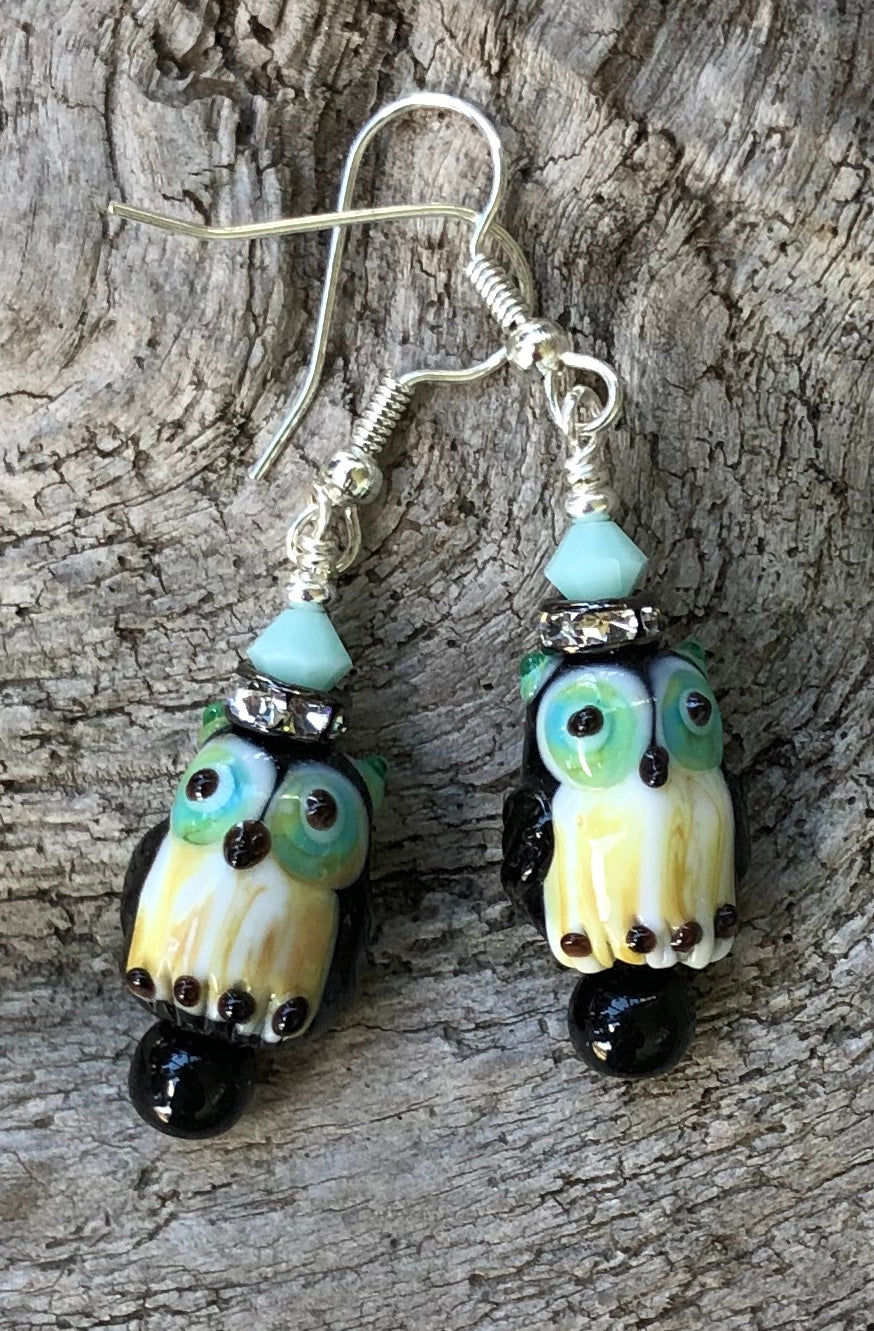 These Black and Aqua Owl Lampwork Glass Earrings are topped with Aqua Swarovski Crystals and measure just under 2