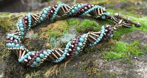 This earth-toned helix spiral bracelet measures 8 1/2" and comprises Czech fire-polished beads in turquoise, brown and bronze.