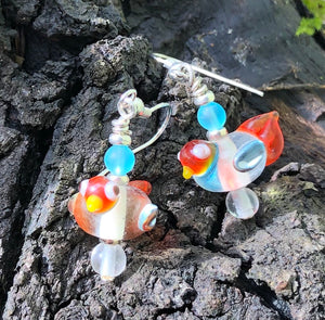 These sweet and tiny clear and orange lampwork glass birds dangles measure 3/4".