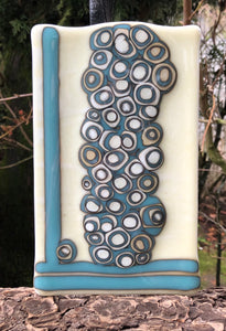 This Fused Glass Art Panel combines Robin’s Egg Blue fused with French Vanilla. There is an unusual reaction that occurs based on the makeup of these two colors. One stack wandered away from the group. 😆 This piece is 5” x 8”. 